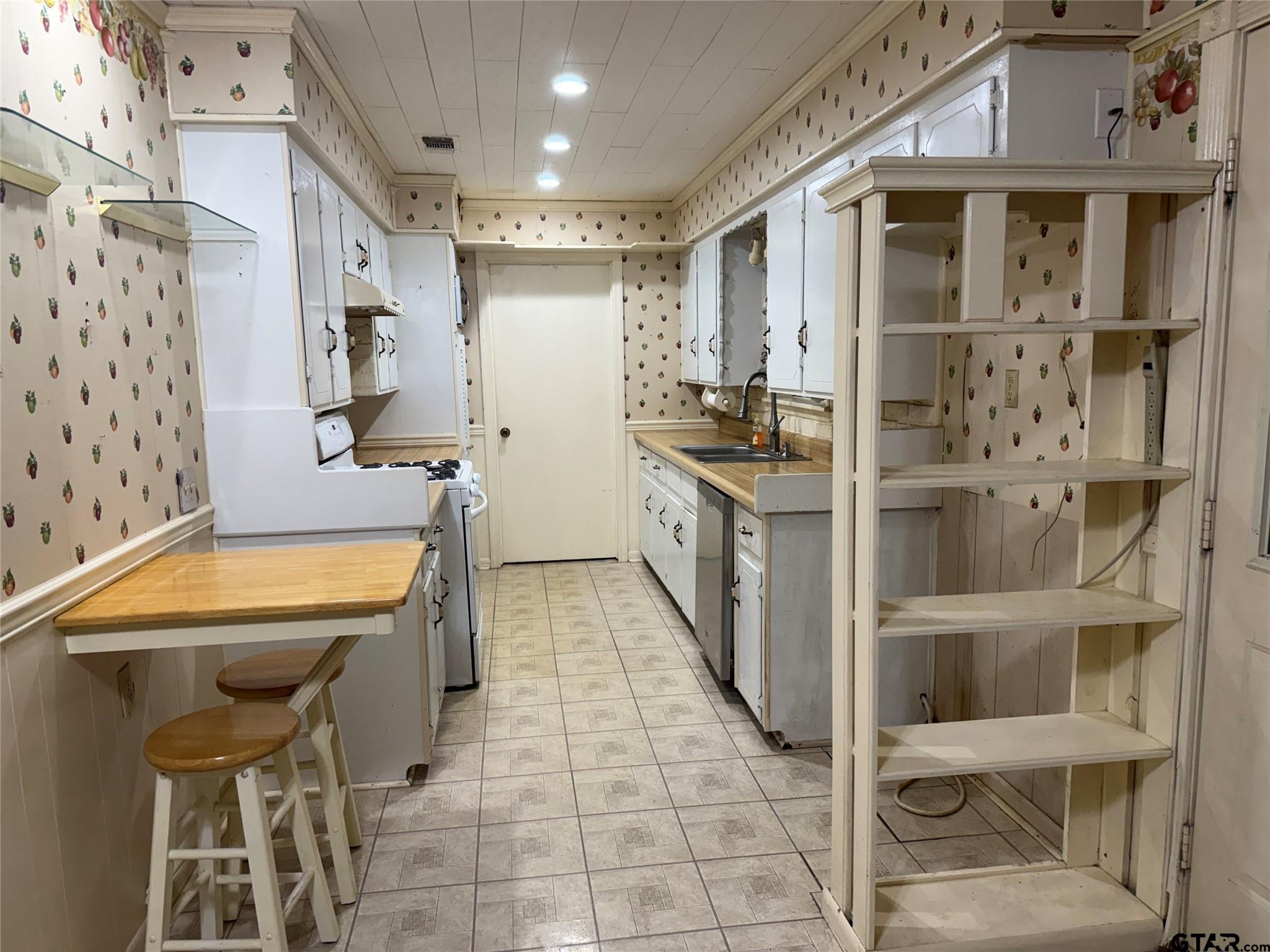 412 South Birch Street Van, TX 75790 - Photo 2 of 9 a kitchen with stainless steel appliances granite countertop a sink and a refrigerator