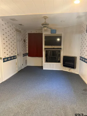 a view of an empty room with a fireplace