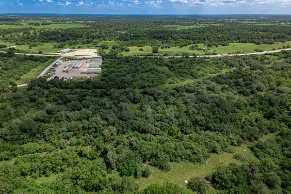 a view of a city with lush green forest
