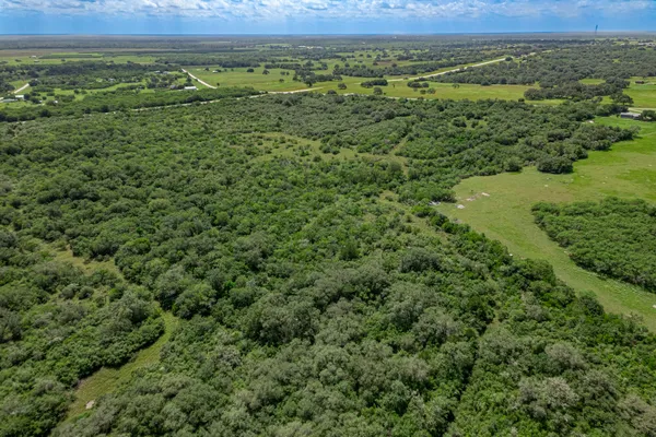 an aerial view of a houses with a yard