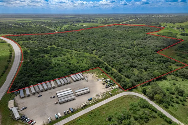 an aerial view of a houses with a yard