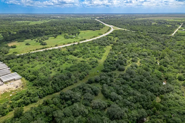 an aerial view of a houses with a yard