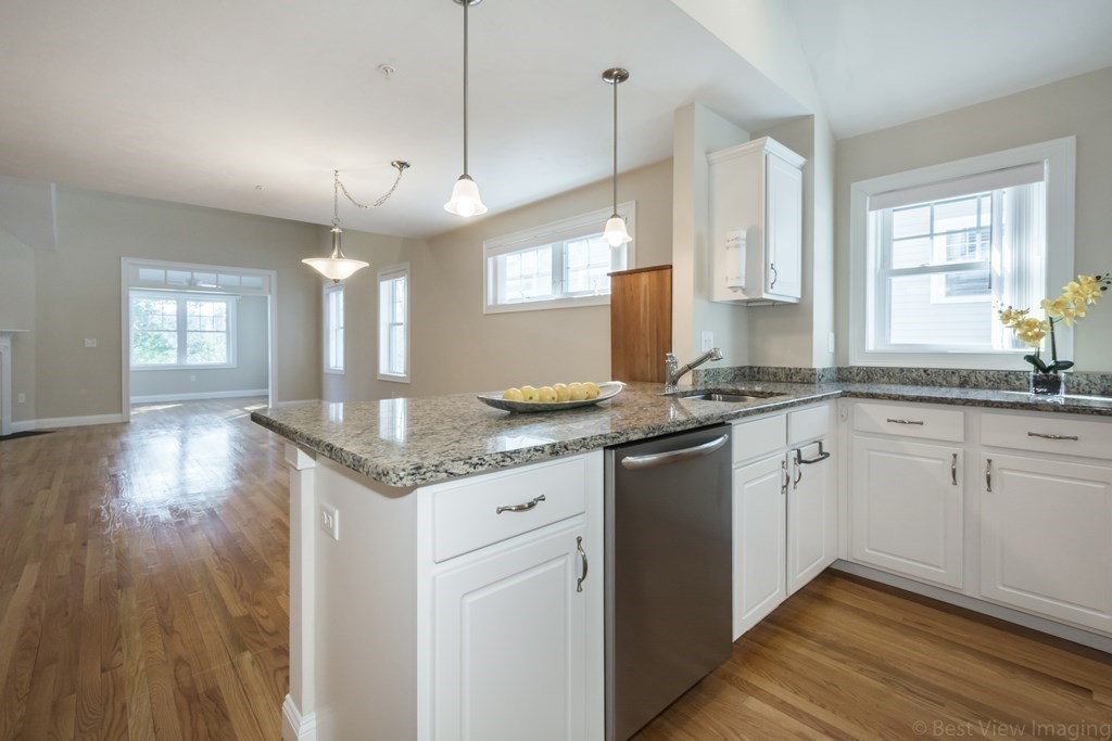 13 Trail Ridge Way, Unit D Harvard, MA 01451 - Photo 12 of 42 a kitchen with granite countertop cabinets a sink dishwasher and a large window