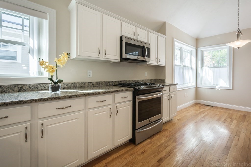 13 Trail Ridge Way, Unit D Harvard, MA 01451 - Photo 13 of 42 a kitchen with granite countertop white cabinets and appliances