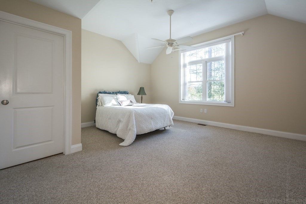 13 Trail Ridge Way, Unit D Harvard, MA 01451 - Photo 20 of 42 a spacious bedroom with a bed and a window
