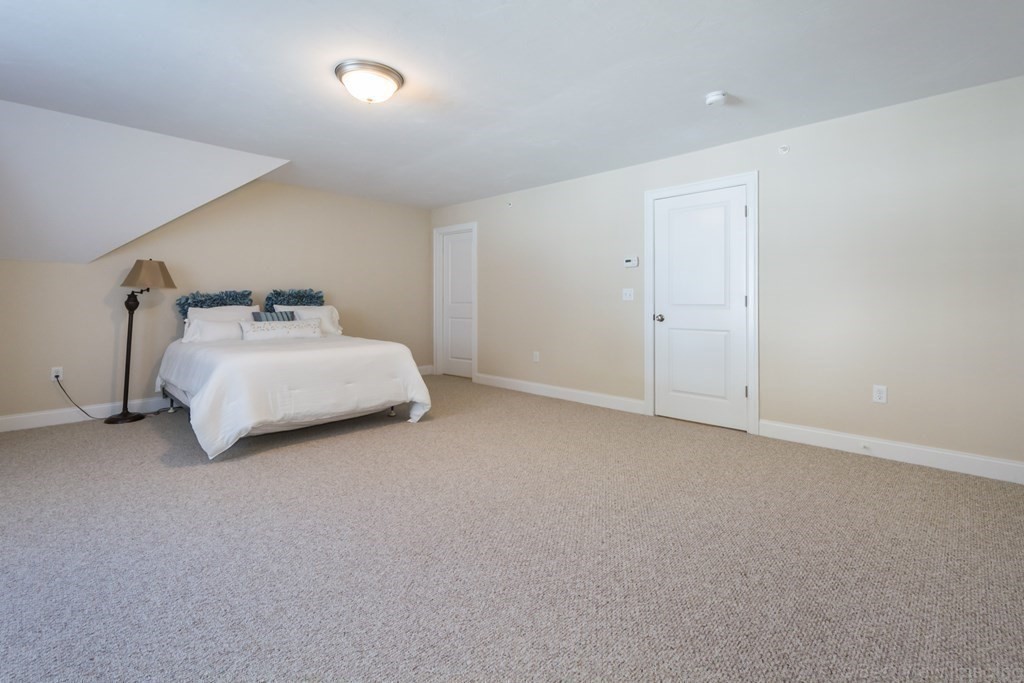 13 Trail Ridge Way, Unit D Harvard, MA 01451 - Photo 25 of 42 a bed room with a bed and a night stand