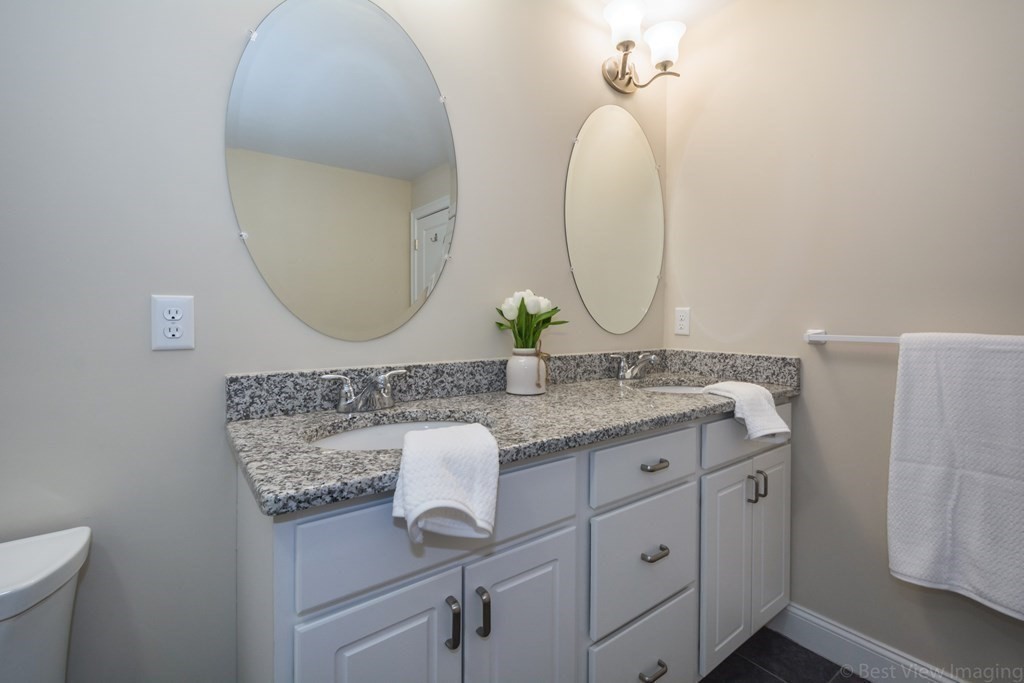 13 Trail Ridge Way, Unit D Harvard, MA 01451 - Photo 26 of 42 a bathroom with a granite countertop sink and a mirror