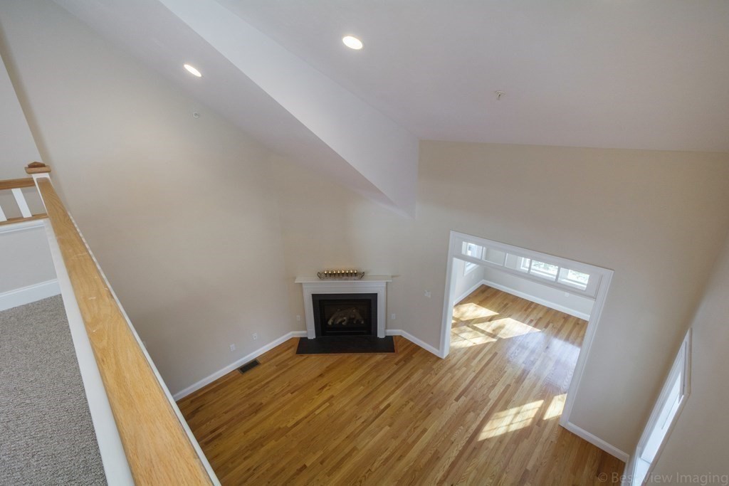 13 Trail Ridge Way, Unit D Harvard, MA 01451 - Photo 32 of 42 a bedroom with a bed and a fireplace