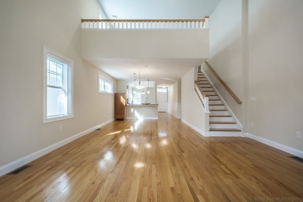 13 Trail Ridge Way, Unit D Harvard, MA 01451 - Photo 6 of 42 a view of a hallway with wooden floor and staircase