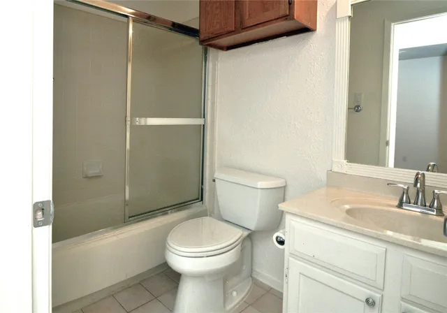 a bathroom with a toilet a sink and shower