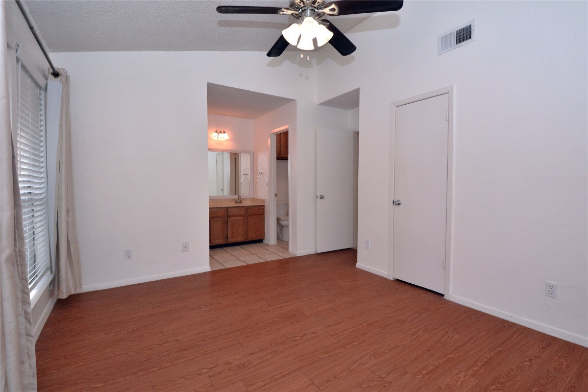3839 Dry Creek Drive, Unit 220 Austin, TX 78731 - Photo 13 of 26 a view of an empty room with a chandelier fan
