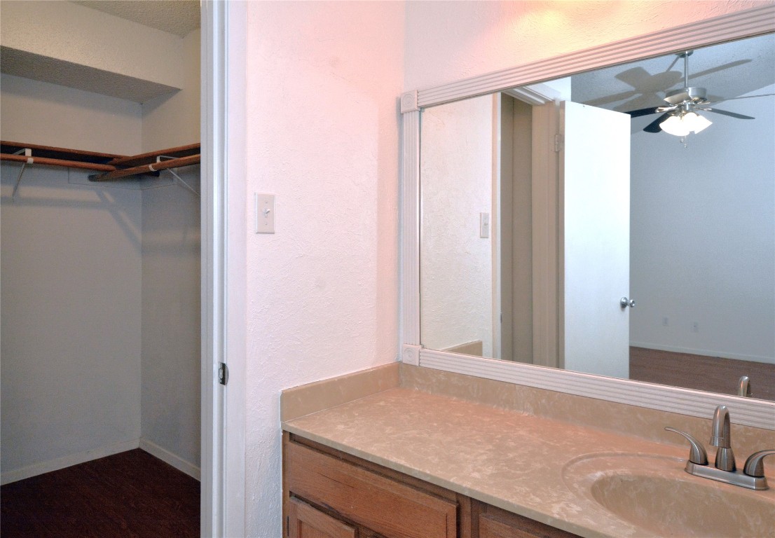 3839 Dry Creek Drive, Unit 220 Austin, TX 78731 - Photo 14 of 26 a bathroom with a granite countertop sink and a mirror