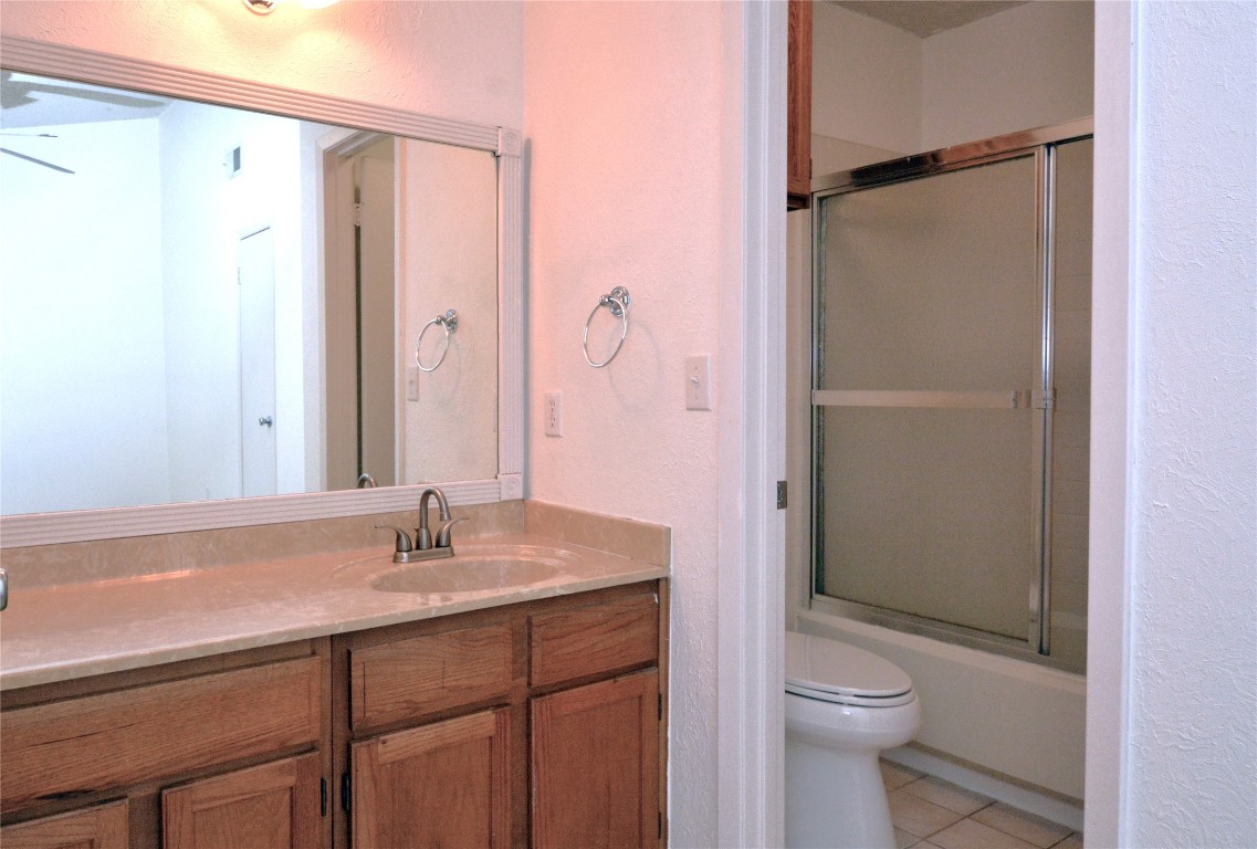 3839 Dry Creek Drive, Unit 220 Austin, TX 78731 - Photo 15 of 26 a bathroom with a sink a toilet and shower