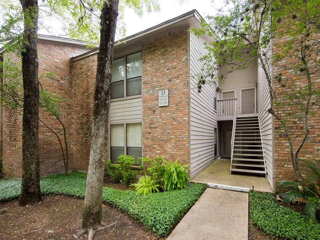 3839 Dry Creek Drive, Unit 220 Austin, TX 78731 - Photo 2 of 26 a front view of a house with garden
