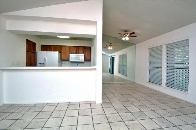 a view of a kitchen with a sink and a mirror
