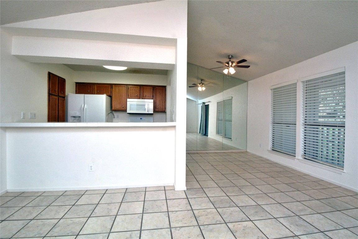3839 Dry Creek Drive, Unit 220 Austin, TX 78731 - Photo 6 of 26 a view of a kitchen with a sink and a mirror