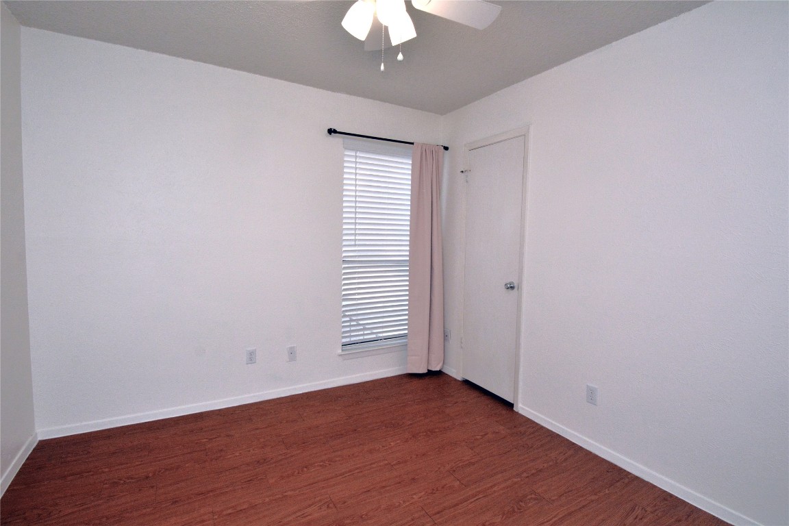 3839 Dry Creek Drive, Unit 220 Austin, TX 78731 - Photo 9 of 26 wooden floor in an empty room with a window