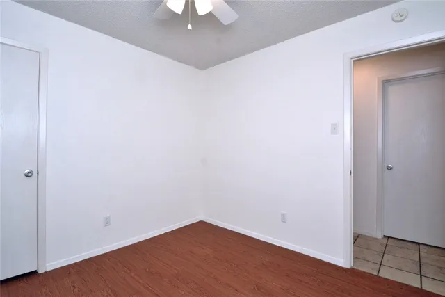 an empty room with wooden floor and closet