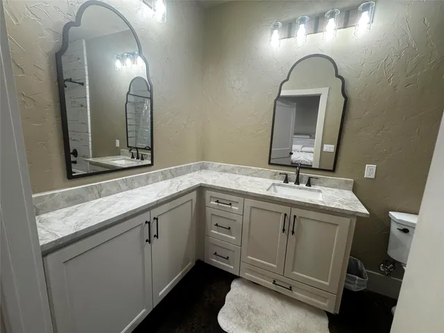 a spacious bathroom with a double vanity sink and a mirror