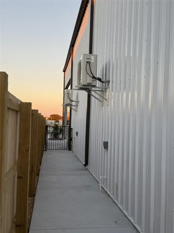 a view of a pathway with a wooden fence