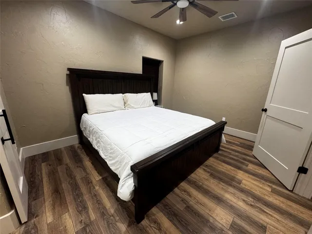 a large bed sitting in a bedroom next to a window