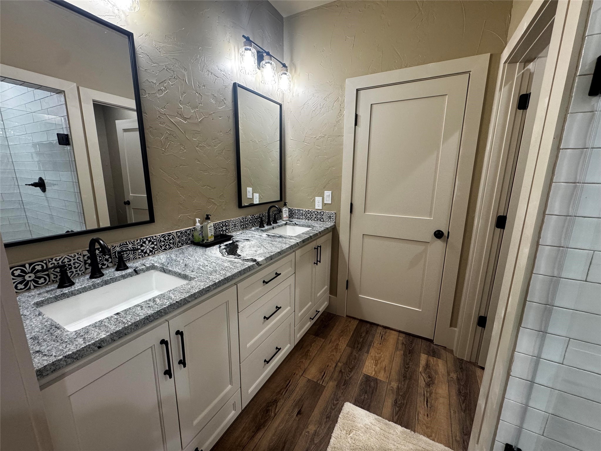 72 Circle Hook Port Port O'Connor, TX 77982 - Photo 28 of 43 a bathroom with a double vanity sink and mirror with shower