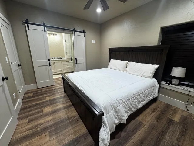 a large bed sitting in a bedroom next to a window