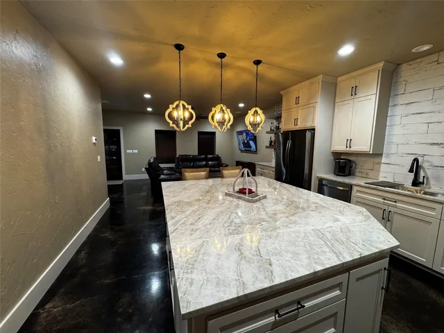 a kitchen with a refrigerator and a sink