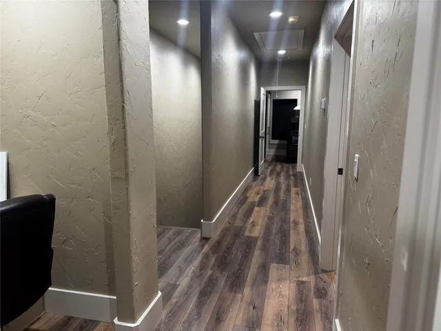 a view of hallway with wooden floor
