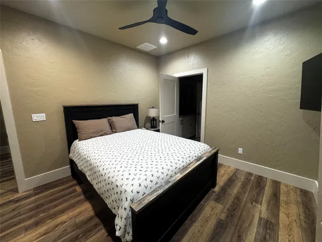 a bed sitting in a bedroom next to a bathroom