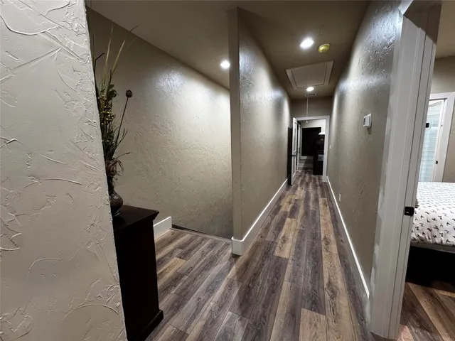 a large bed in a bedroom next to a window