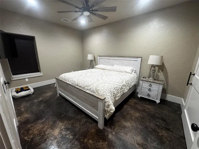 a bedroom with a bed and a flat tv screen on the wall
