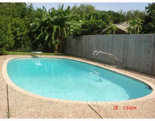 a view of a backyard with a small pool