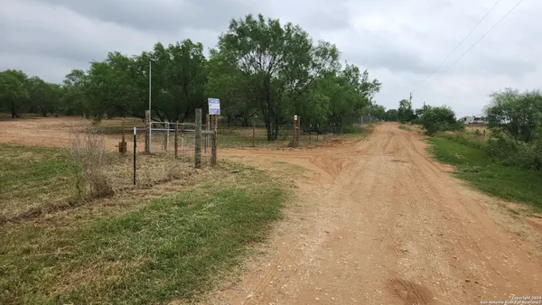a swimming pool with outdoor seating and green space