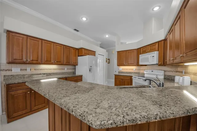a bathroom with a granite countertop sink a toilet and a mirror