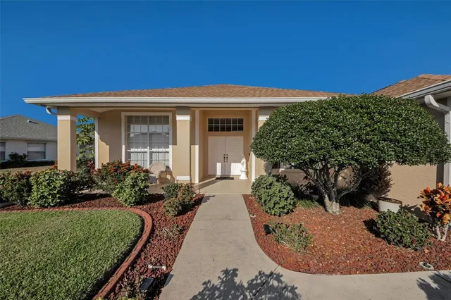 a view of a house with potted plants