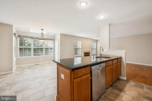 a kitchen with stainless steel appliances granite countertop a sink and a stove