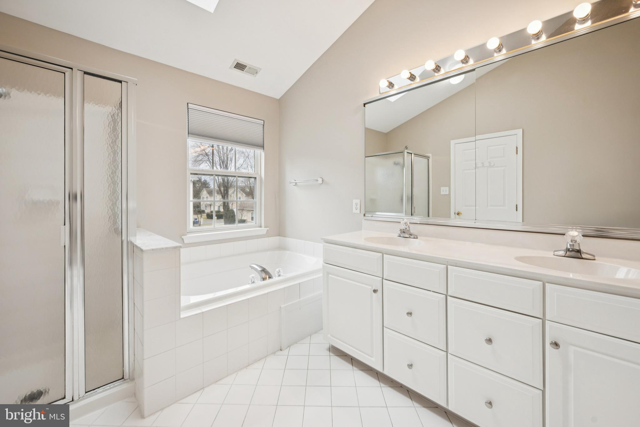 16 Hogan Way Moorestown, NJ 08057 - Photo 19 of 25 a bath room with a sink a mirror a vanity and a bathtub