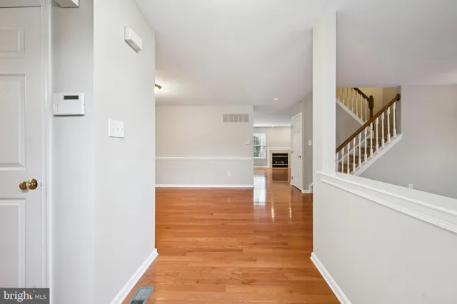 a view of a hallway view with wooden floor and staircase