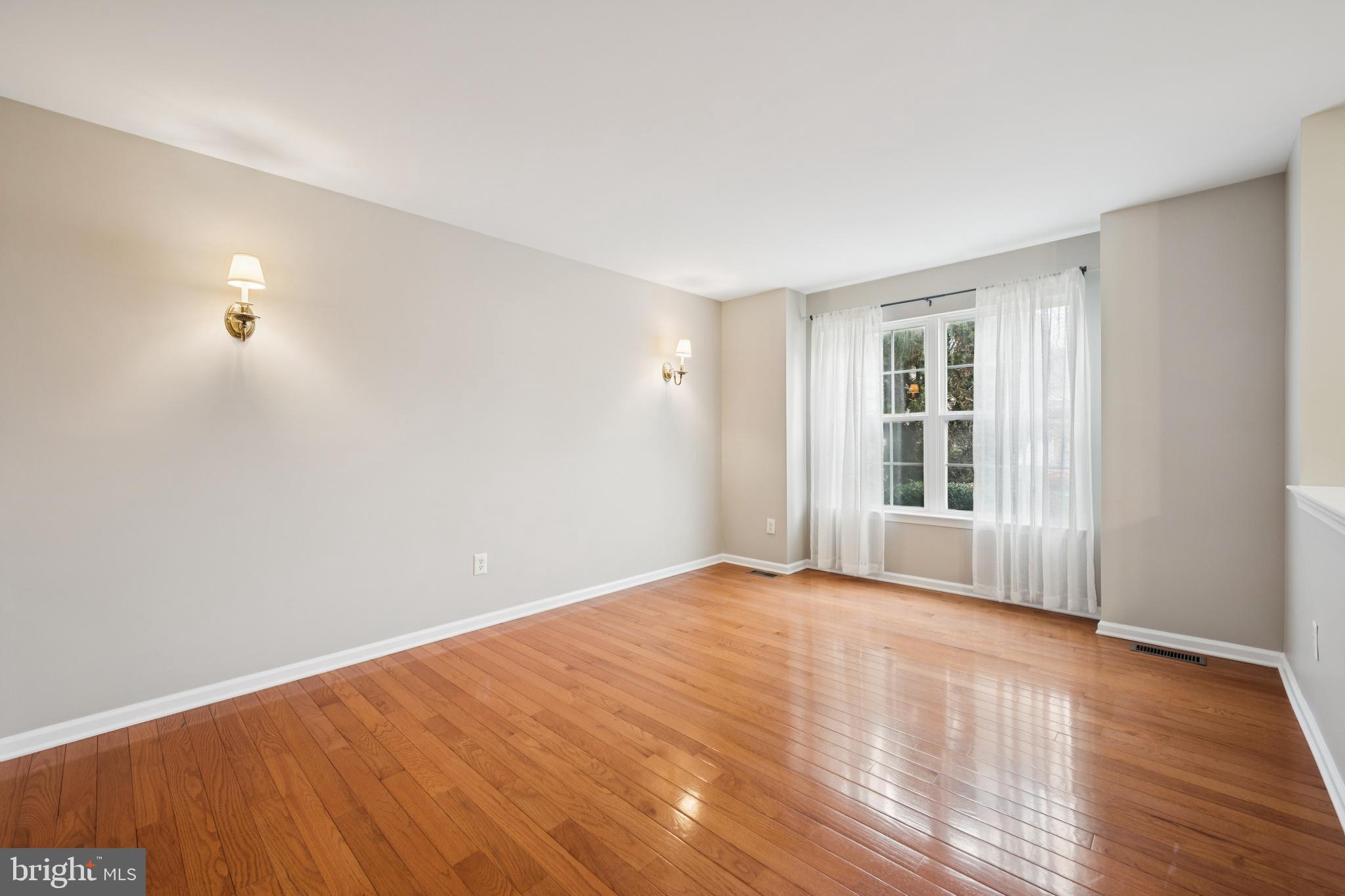 16 Hogan Way Moorestown, NJ 08057 - Photo 4 of 25 a view of an empty room with wooden floor and a window