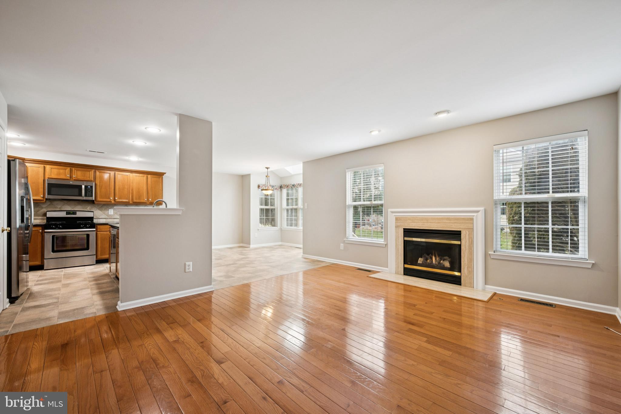 16 Hogan Way Moorestown, NJ 08057 - Photo 10 of 25 an empty room with wooden floor a fireplace and window