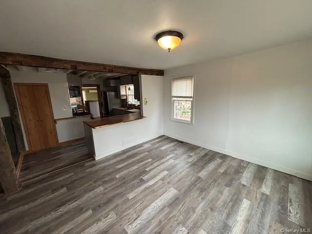 a view of a living room a window and wooden floor