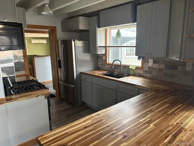 a kitchen with a sink stove and refrigerator