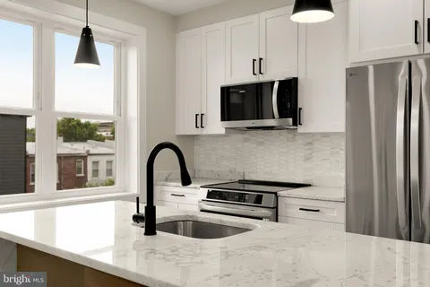 a kitchen with stainless steel appliances a refrigerator a stove a microwave and cabinets