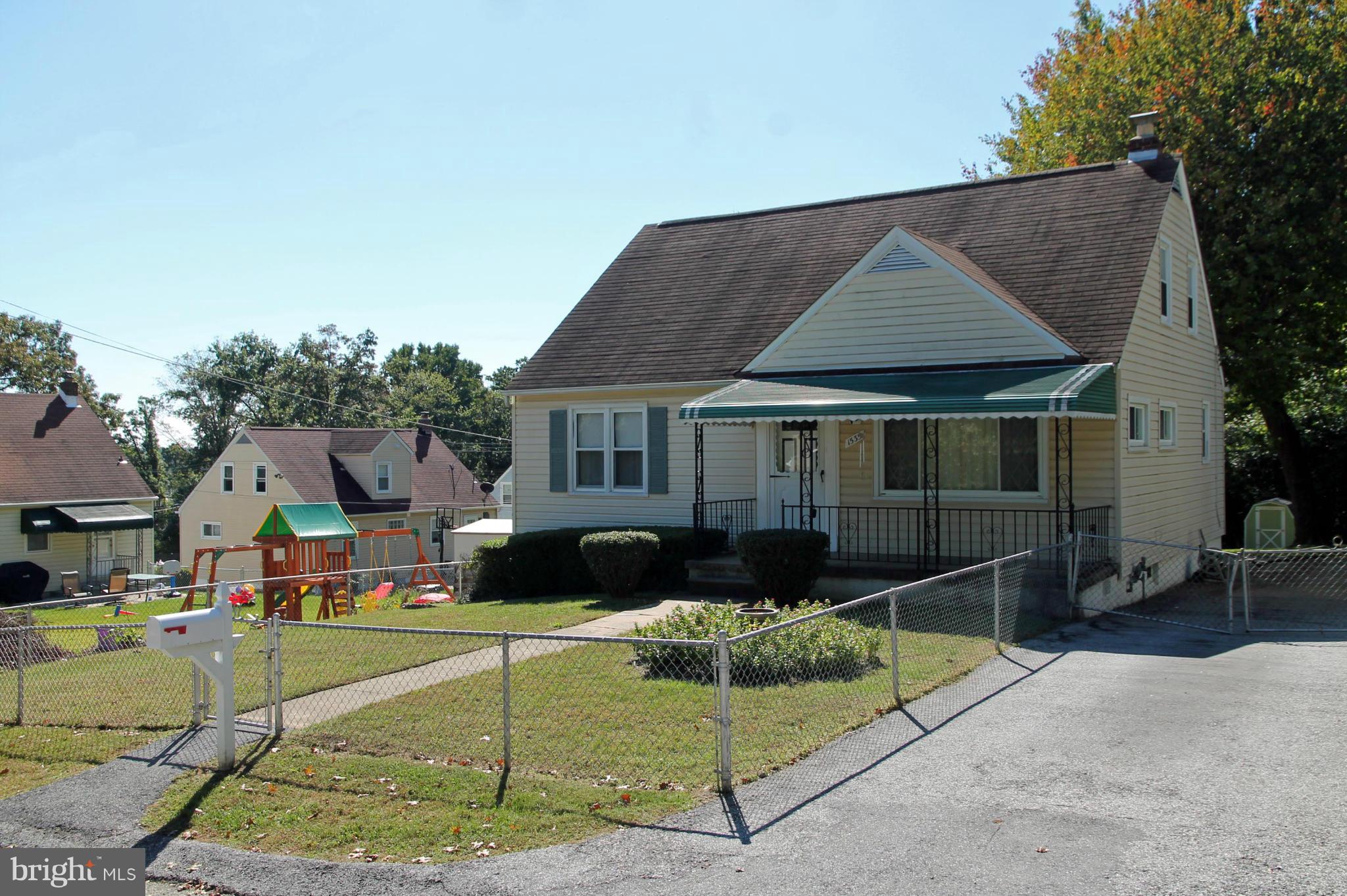 Front of house - porch, driveway, fence