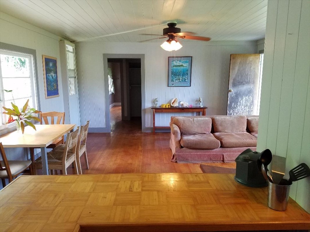 87-3460 Hawaii Belt Road Captain Cook, HI 96704 - Photo 19 of 25 a living room with furniture a dining table and a fireplace