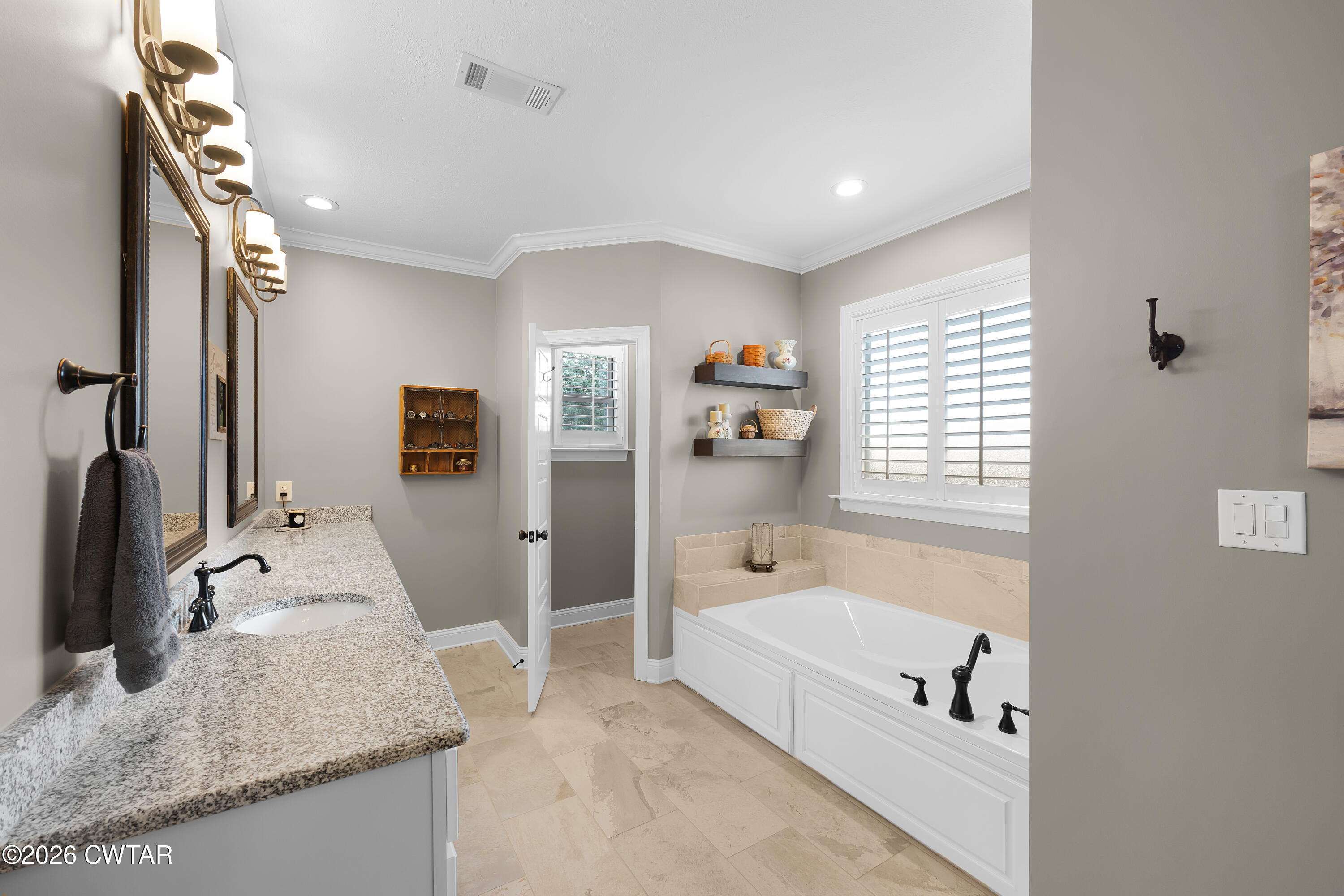 34 Cheddleton Cove Jackson, TN 38305 - Photo 14 of 32 a spacious bathroom with a granite countertop tub sink and mirror