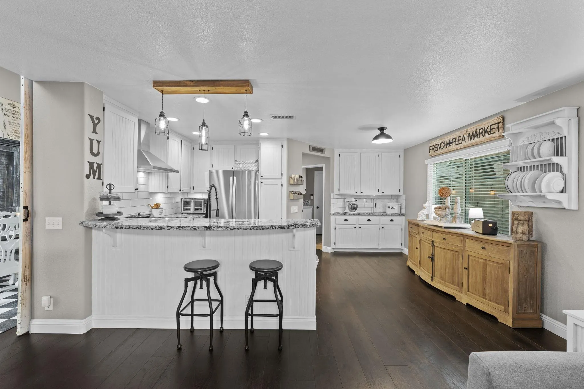 1846 Corte Pulsera Oceanside, CA 92056 - Photo 12 of 30 a kitchen with stainless steel appliances kitchen island wooden floors and white cabinets