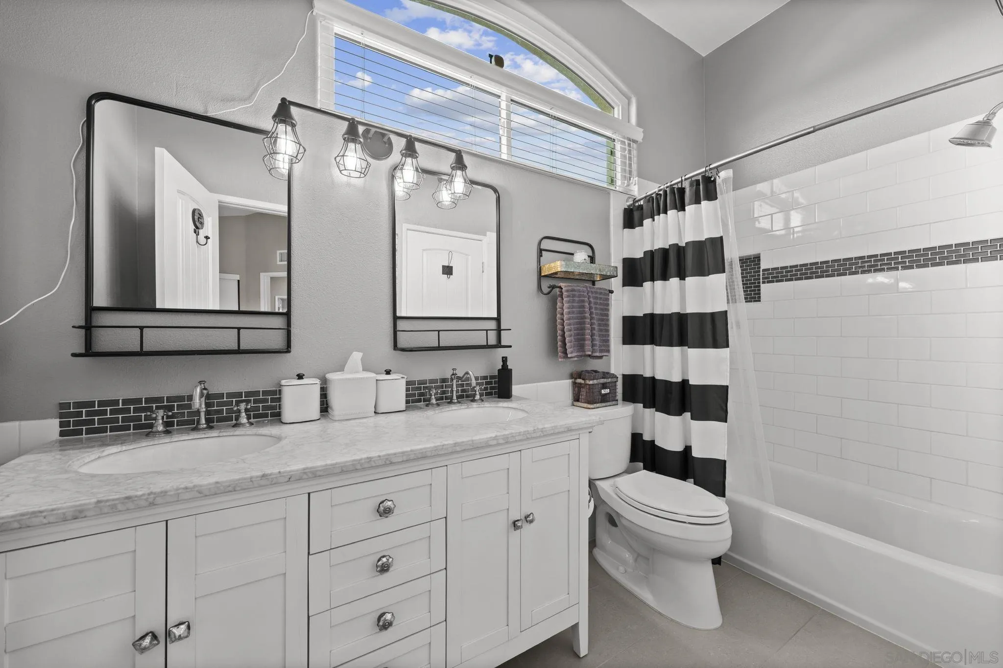 1846 Corte Pulsera Oceanside, CA 92056 - Photo 22 of 30 a bathroom with a granite countertop sink a toilet a mirror a bathtub and shower