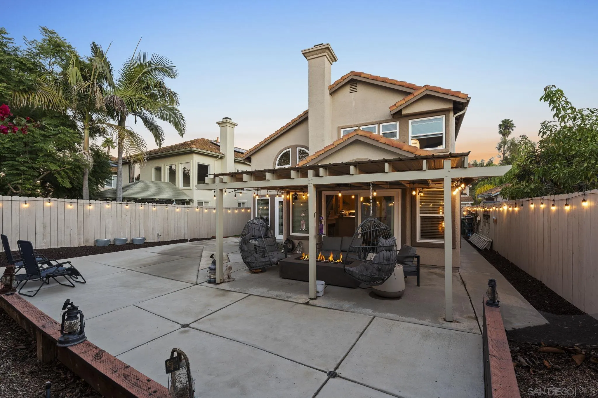 1846 Corte Pulsera Oceanside, CA 92056 - Photo 5 of 30 a view of a white house with large windows and a table